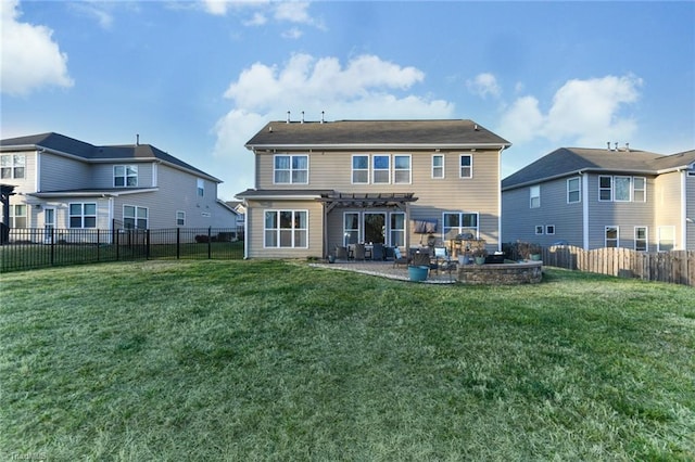 rear view of property featuring a yard, a pergola, and a patio