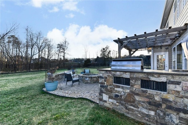 view of patio with area for grilling, an outdoor fire pit, grilling area, and a pergola