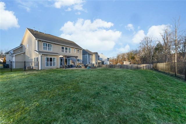 back of house with a yard and a pergola