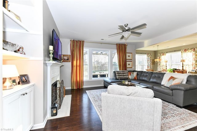 living room featuring dark hardwood / wood-style floors and ceiling fan