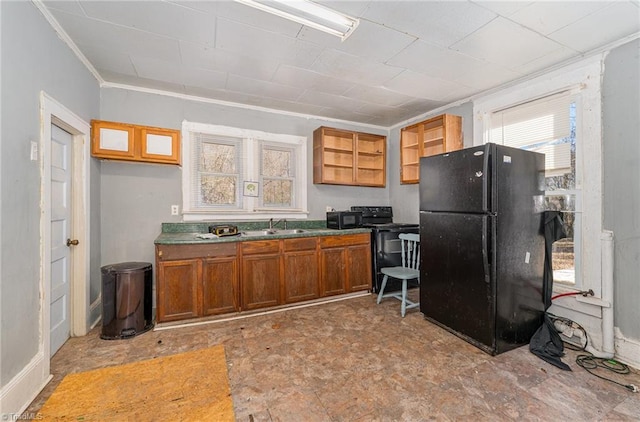 kitchen featuring black appliances, ornamental molding, and sink