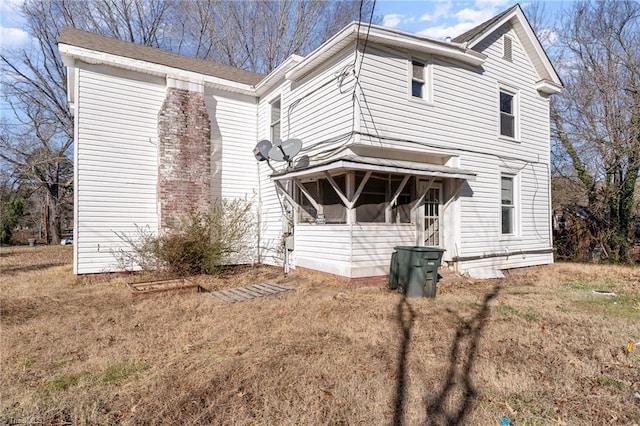 view of front of home with a sunroom and a front yard