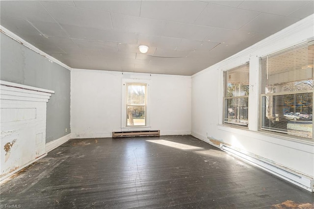 unfurnished living room with dark hardwood / wood-style flooring, ornamental molding, and a baseboard heating unit