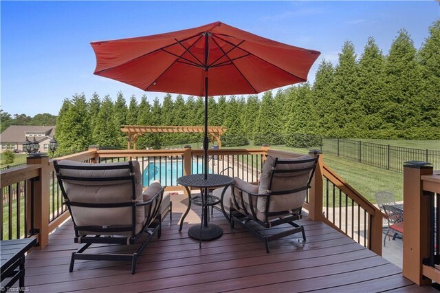 wooden terrace featuring a forest view