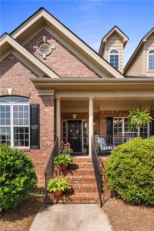 doorway to property with brick siding and a porch