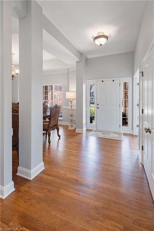 foyer entrance featuring wood finished floors and baseboards
