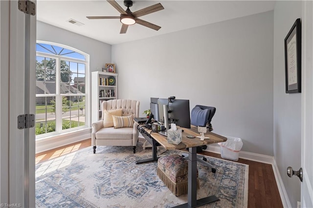 office space featuring wood finished floors, ceiling fan, and baseboards