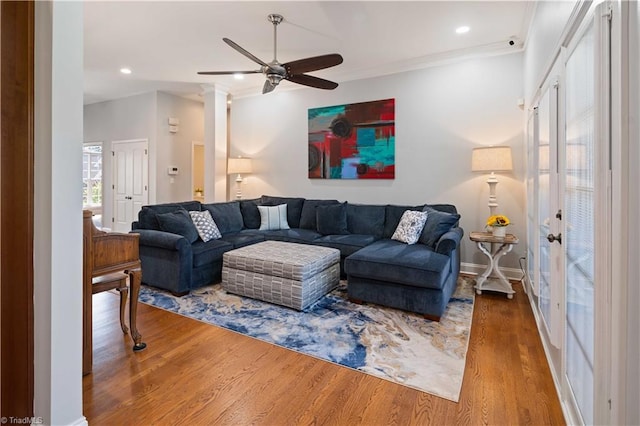 living area featuring ceiling fan, wood finished floors, ornamental molding, recessed lighting, and french doors