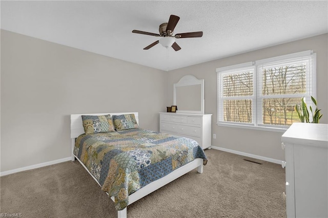 bedroom with a textured ceiling, ceiling fan, and carpet flooring