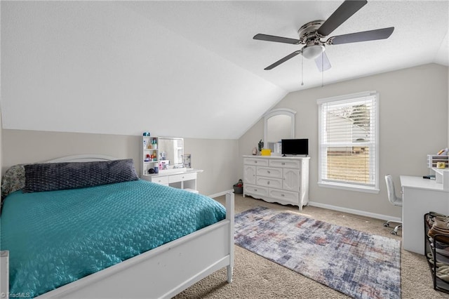 bedroom with vaulted ceiling, light colored carpet, and ceiling fan