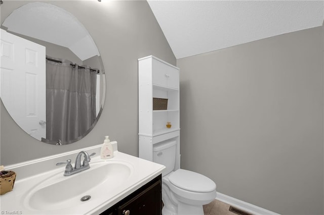 bathroom with vanity, lofted ceiling, toilet, and a shower with shower curtain