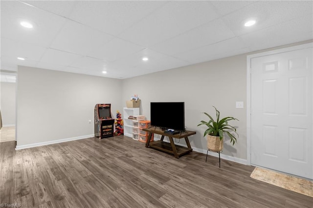 interior space featuring dark hardwood / wood-style floors and a drop ceiling