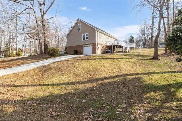 view of home's exterior featuring a yard, a garage, and a wooden deck