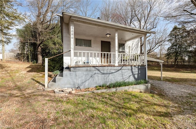 view of front of property with a porch and a front yard