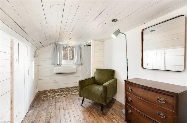 living area with light wood finished floors, lofted ceiling, wooden ceiling, cooling unit, and wood walls