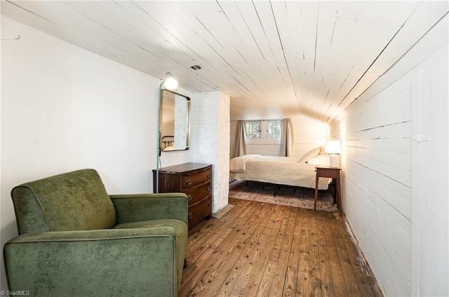 bedroom with lofted ceiling, wood-type flooring, and wooden ceiling