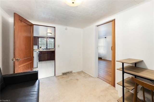 dining area with visible vents, crown molding, and light colored carpet