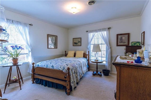 bedroom with ornamental molding, light carpet, visible vents, and baseboards