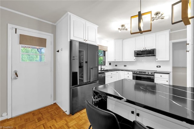 1508 Lafayette Ct, Greensboro, NC 27408 - kitchen featuring stainless steel appliances, a sink, white cabinets, crown molding, and dark countertops