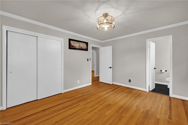 1508 Lafayette Ct, Greensboro, NC 27408 - unfurnished bedroom with a chandelier, baseboards, crown molding, light wood-type flooring, and connected bathroom