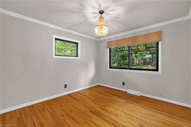 1508 Lafayette Ct, Greensboro, NC 27408 - unfurnished room featuring baseboards, a chandelier, light wood-type flooring, and ornamental molding