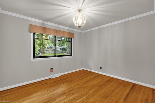 1508 Lafayette Ct, Greensboro, NC 27408 - empty room featuring a chandelier, baseboards, light wood-style floors, and crown molding