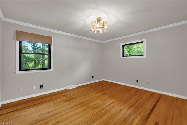 1508 Lafayette Ct, Greensboro, NC 27408 - spare room with a chandelier, baseboards, crown molding, and light wood-type flooring
