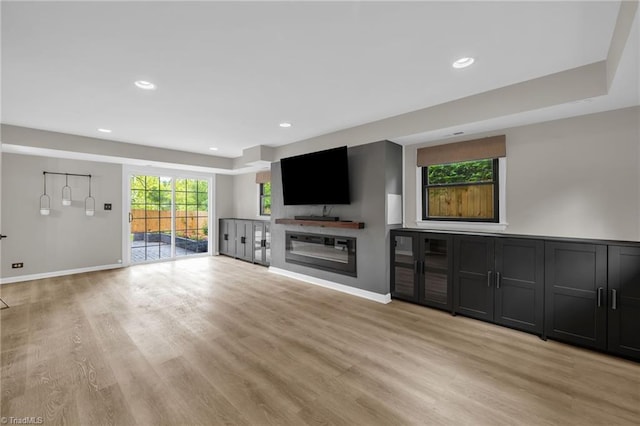 1508 Lafayette Ct, Greensboro, NC 27408 - unfurnished living room with light wood-style floors, baseboards, recessed lighting, and a glass covered fireplace