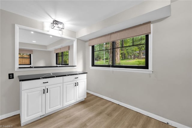 1508 Lafayette Ct, Greensboro, NC 27408 - kitchen with dark countertops, baseboards, white cabinetry, light wood-type flooring, and recessed lighting