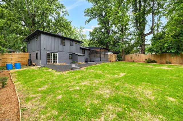 1508 Lafayette Ct, Greensboro, NC 27408 - back of house featuring a sunroom and board and batten siding