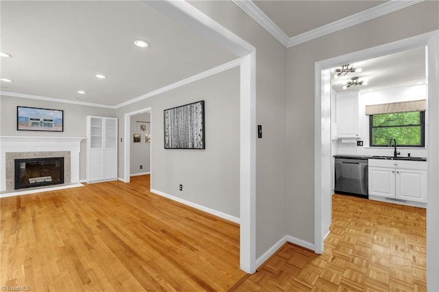 1508 Lafayette Ct, Greensboro, NC 27408 - unfurnished living room featuring a sink, baseboards, ornamental molding, recessed lighting, and a glass covered fireplace