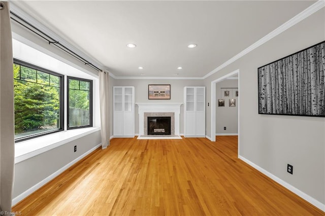 1508 Lafayette Ct, Greensboro, NC 27408 - unfurnished living room featuring baseboards, light wood-type flooring, ornamental molding, recessed lighting, and a fireplace with raised hearth
