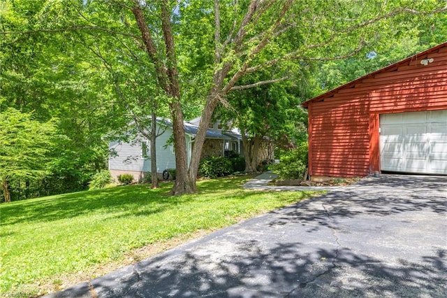 1134 Edwards Farm Rd, King, NC 27021 - view of grassy yard featuring asphalt driveway and a garage