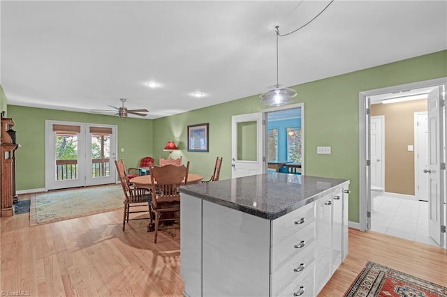 1134 Edwards Farm Rd, King, NC 27021 - kitchen featuring ceiling fan, white cabinetry, light wood-style floors, a kitchen island, and french doors