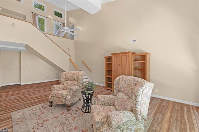 1134 Edwards Farm Rd, King, NC 27021 - sitting room with a towering ceiling, wood finished floors, stairway, a ceiling fan, and baseboards