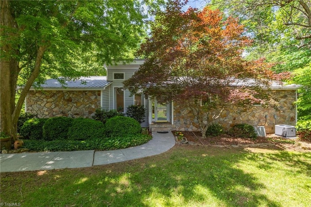 1134 Edwards Farm Rd, King, NC 27021 - view of property hidden behind natural elements featuring stone siding, a front lawn, central AC unit, metal roof, and a standing seam roof