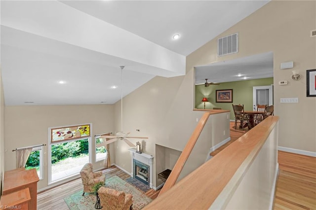 1134 Edwards Farm Rd, King, NC 27021 - stairs with a ceiling fan, high vaulted ceiling, wood finished floors, a fireplace, and baseboards
