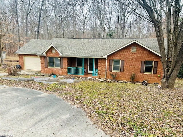 single story home featuring a garage and covered porch