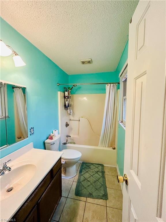 full bathroom with toilet, shower / tub combo, a textured ceiling, tile patterned floors, and vanity