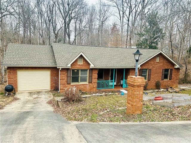 ranch-style house with a garage and a porch