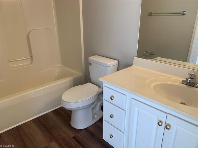 full bath with toilet, vanity,  shower combination, and wood finished floors