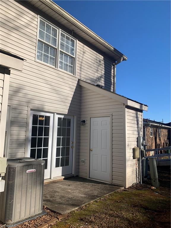 rear view of house featuring central air condition unit and a patio