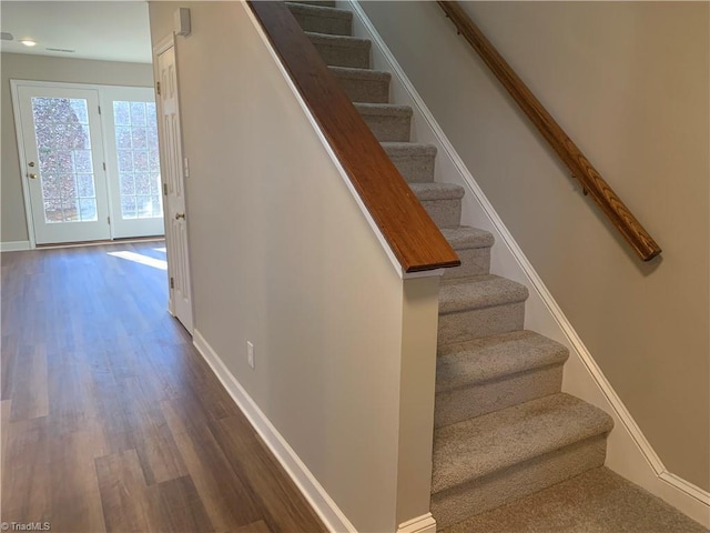 stairs with baseboards and wood finished floors