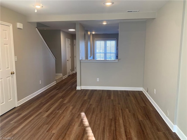 unfurnished room with baseboards and wood finished floors