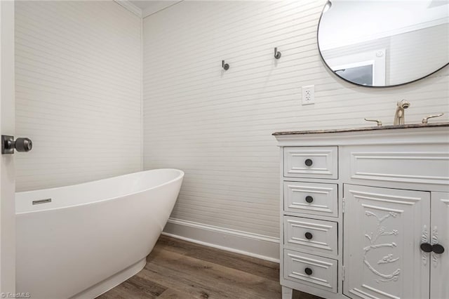 bathroom featuring sink, hardwood / wood-style floors, and a tub to relax in