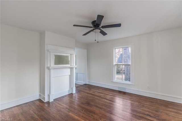 unfurnished living room featuring dark wood-type flooring and ceiling fan