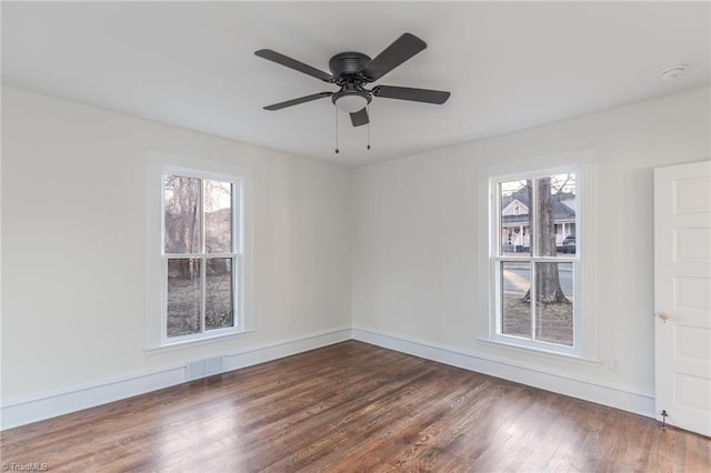 spare room featuring ceiling fan and dark hardwood / wood-style flooring