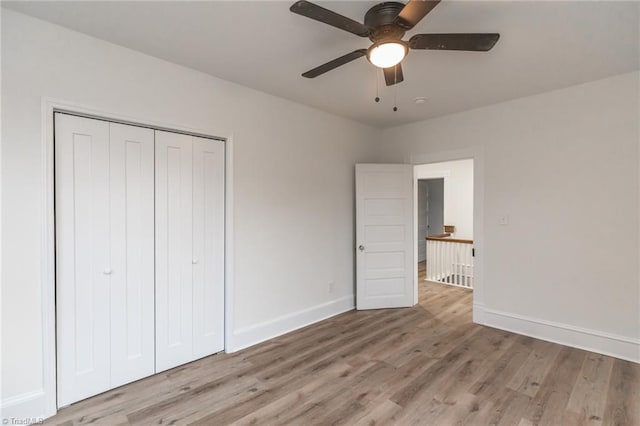 unfurnished bedroom featuring a closet, ceiling fan, and light hardwood / wood-style flooring