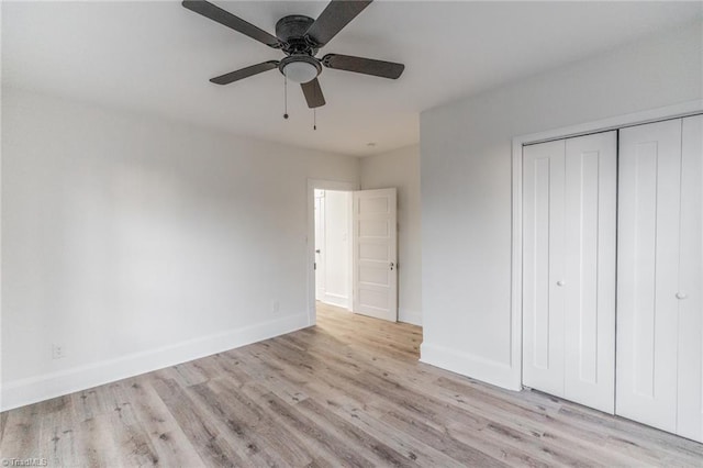 unfurnished bedroom with ceiling fan, a closet, and light wood-type flooring