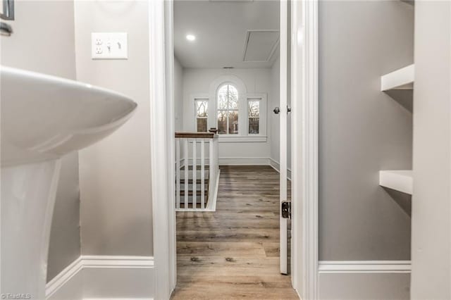 hallway with hardwood / wood-style flooring